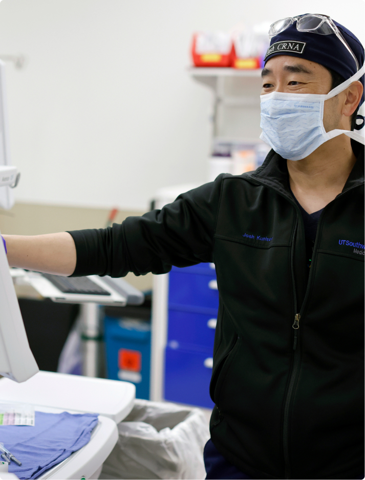 APP_Adult_Modality Male advanced practice provider employee with a mask working